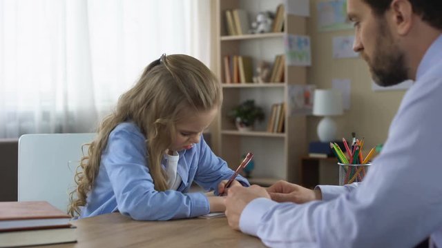Strict father making capricious daughter to do homework, control and education
