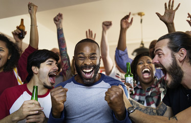 Frieds cheering sport at bar together