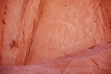 Spiral petrogyph on a red rock cliff face in the Bears Ears wilderness of Southern Utah
