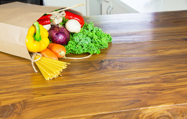 Fresh Organic Raw Vegetables food delivery in paper bag on wooden bench