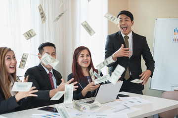 Asian business man and woman groups, successful business. There is a lot of money. with a laptop at office desk and document. business success concept