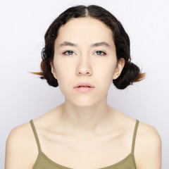 Young cheerful  girl  looking at camera over white background.