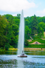 Photo of fountain among tha lake in the park at summer