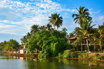 Fototapeta na wymiar River on the beach in Mandrem with views of buildings in North Goa.India 