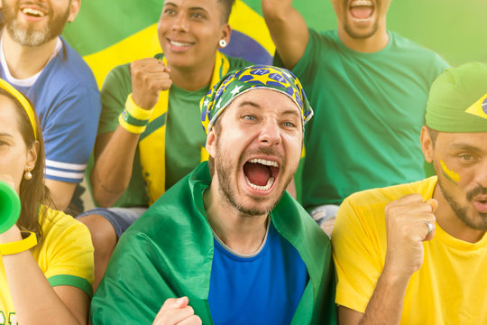 Brazilian supporters at stadium bleachers. Goal, victory, celebration.
