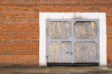 gray large garage door brick with a lock on the door