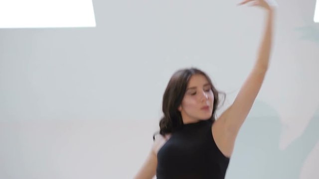 Sexy girl in black clothing dance dancing sensual dance in the Studio on a white background. (kizomba, bachata, semba, taraxia, latino) Passionate salsa dancers.