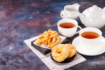 Eclairs and tea on a table. Selective focus. Copy space. Top view