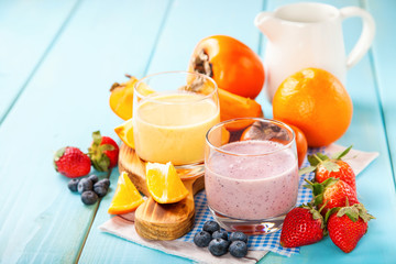 Orange persimmon blueberry smoothie with granola  and fruits. Selective focus. Copy space