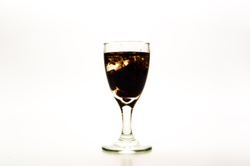 Brown / Chocolate food coloring diffuse in water inside wine glass with empty copy-space area for slogan or advertising text message, over isolated white background.
