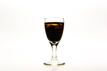 Brown / Chocolate food coloring diffuse in water inside wine glass with empty copy-space area for slogan or advertising text message, over isolated white background.
