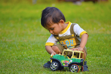 Cute Baby playing with toy car , Pune, Maharashtra.