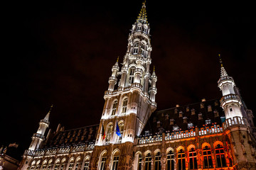The belfry tower of Brussels is illuminated and lit up at night, Belgium