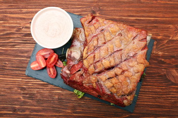 Delicious smoked beef ribs on an old rustic wooden chopping boar