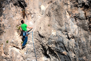 A man climbs the rock.