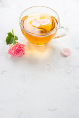 Cup of tea and tender pink roses on a white background copy space