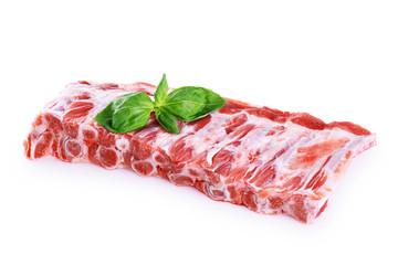 Raw fresh pork ribs and basil isolated on white background.