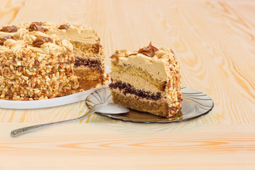 Fragment of the partly cut layered sponge cake