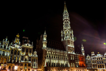 Fototapeta na wymiar The townhall and belfry tower of Brussels is illuminated and lit up at night, Belgium