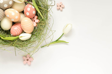 Easter egg decoration with pastel colors, top view. Empty space on the right.