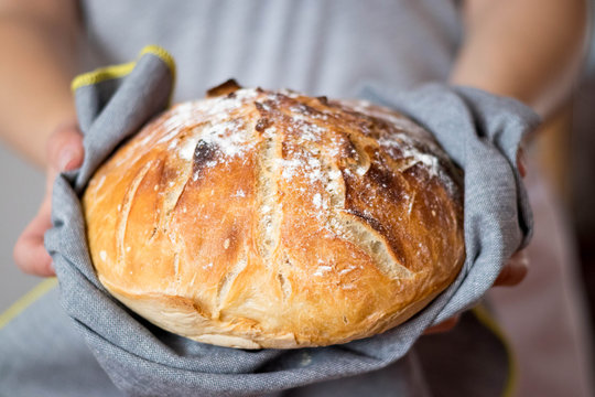 Closeup of fresh homemade bread in a woman's hand