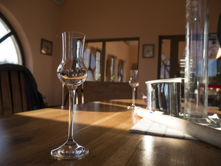 empty alcohol glass on wooden table during destilation of spirits, degustation