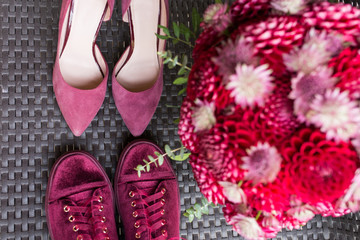 Wedding Heels VS bridal sneakers. Red wedding bridal accessories: bridal heels and sneakers of marsala color, red bridal bouquet from dahlias. Wedding details. 