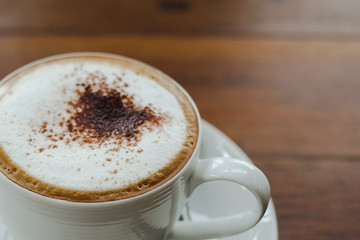 Coffee cup on wooden background