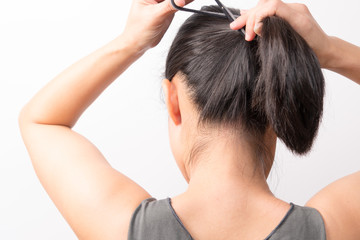 rear view of women tightening the hair, lifestyle concept