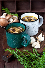 Mushroom soup with croutons in ceramic mug on rustic wooden background - healthy organic homemade vegetarian vegan delicious soup meal lunch food