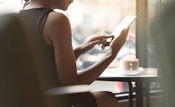 woman using tablet in coffee shop