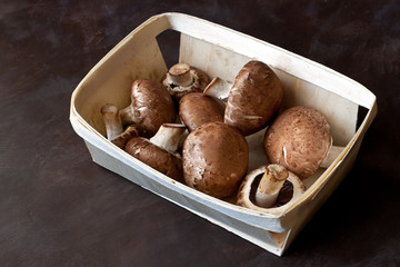 Fresh champignon mushrooms on wooden table. Top view