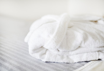 White bathrobe on the bed in the spa salon