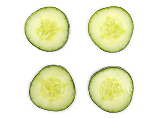 Cucumber slices isolated on white background, top view