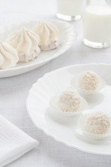 White sweets and cakes on a light background