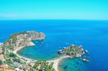 Obraz premium Panoramic view of Isola Bella bay, with its little island at the centre near Taormina, Sicily,Italy.The Pearl of the Ionian Sea