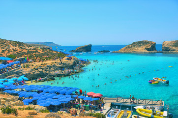 Blue Lagoon, located on Malta's smallest island - Comino, with its turquoise waters and golden rocks, is a paradise for snorkelers, divers, windsurfers and ramblers. - obrazy, fototapety, plakaty