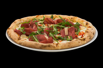 pizza with cheese, prosciutto and rucola isolated on black background
