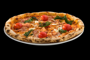 pizza with cherry tomatoes, cheese, Ham and basil isolated on black background