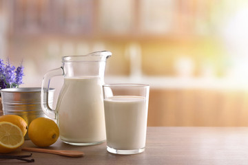 Glass of milk on wooden bench in a rustic kitchen