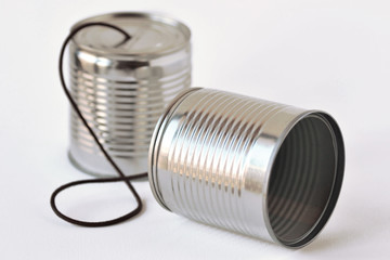 Tin cans phone on white background - Communication concept