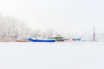 blew ship moored on river bank, covered with snow. winter day, in Russia.