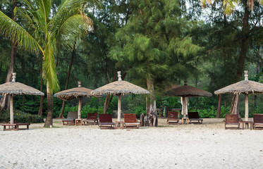Lounge chairs and sunshade umbrella on the beach