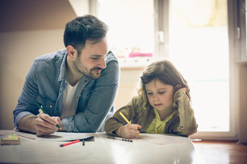 Single father drawing with daughter.