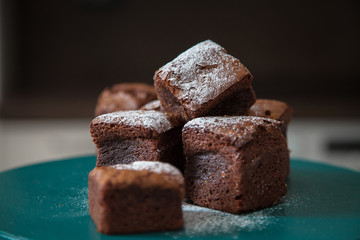  Chocolate dessert on a bright background with powdered sugar.