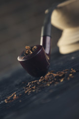 pipe  tobacco on a wooden bg close up toning shot