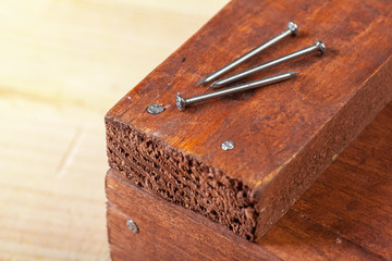 iron nails on a wooden table