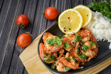 Roasted shrimps with lemon, garlic,herbs and white rise, seafood shelfish shrimps prawns grilled with spices