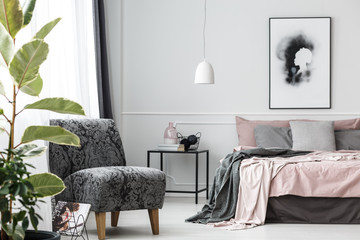Grey patterned armchair in bedroom