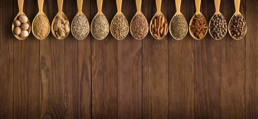Keuken foto achterwand collection of Indian spices and herbs on  background  wooden table. Seasoning in spoons, top view © dmitr1ch